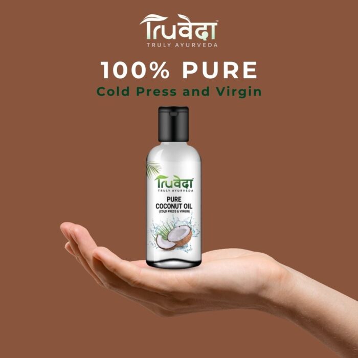Hand holding a bottle of Truveda virgin coconut oil promoting purity and wellness, ideal for hair, skin, and cooking
