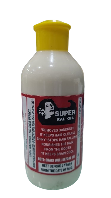 Bottle of Super Ral Oil with label highlighting benefits like dandruff removal, reduced hair fall, root nourishment, and scalp cooling